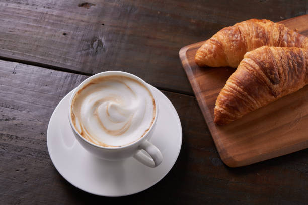istock Cafe au lait with a wooden background 1488487003