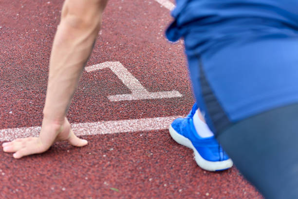 istock fast runner in blue sneakers is ready to run on track number one 1488487840