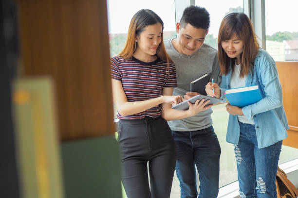 istock Student groups are viewing information in books and laptops. Willing to study together 1488488431