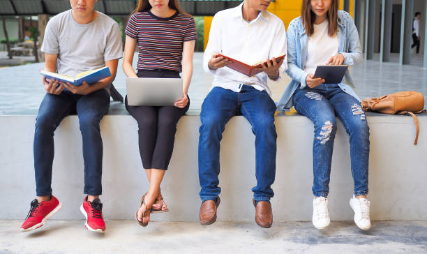 istock A group of students are sitting on a counsellor doing their homework or reading a book preparing for an exam in an open space. Students studying in groups outside. 1488488441