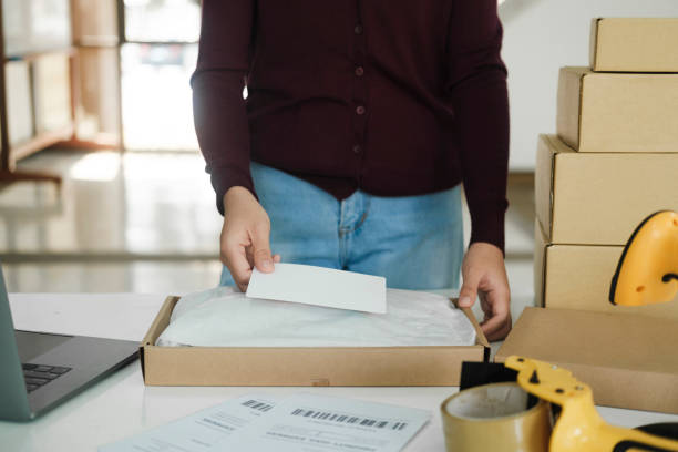 istock Female online business owner packing package. 1488488525