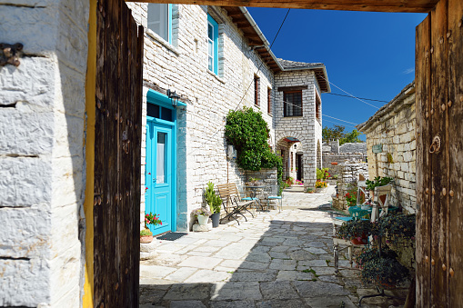 Afionas, Corfu, Greece - October 04, 2020: Footpath through Afionas, a colorfully planted little mountain village near the Porto Timoni beach.