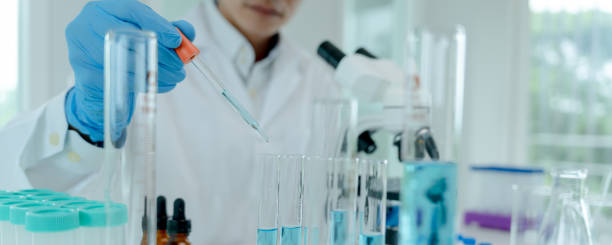 istock Scientist analyze biochemical samples in advanced scientific laboratory. Medical professional use dropper mix microbiological developmental of viral. Biotechnology research in  science lab. 1488489615