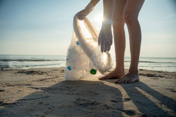 istock Save water. Volunteer pick up trash garbage at the beach and plastic bottles are difficult decompose prevent harm aquatic life. Earth, Environment, Greening planet, reduce global warming, Save world 1488489812