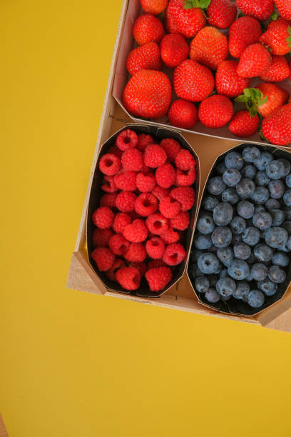 istock Assorted berries set. Summer berry harvest. Strawberries, raspberries, blueberries, berries close-up on a yellow background. Healthy Sweet Dessert. 1488491106