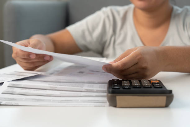 istock Woman working on financial bill paper document doing home accounting 1488494011