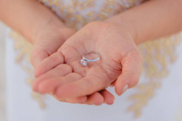 istock Wedding rings on the palm close-up with a blurred background. 1488497255