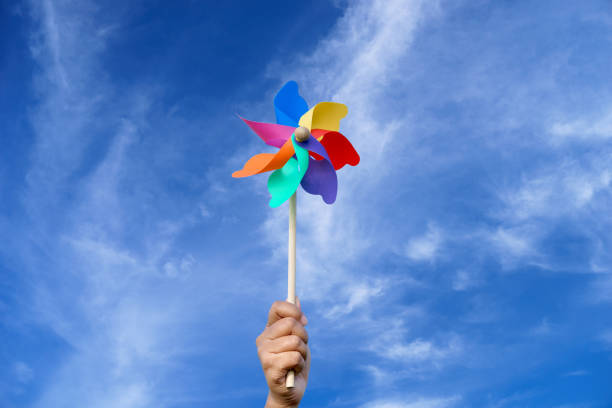 istock Wind turbine paly on hand with blue sky. 1488498200