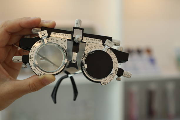 istock Hand holding trial frame, trial frame glasses in hand 1488499212