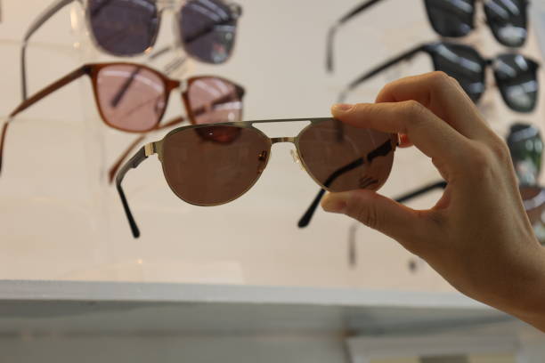 istock Hand holding sunglasses in eyeglasses shop 1488499396