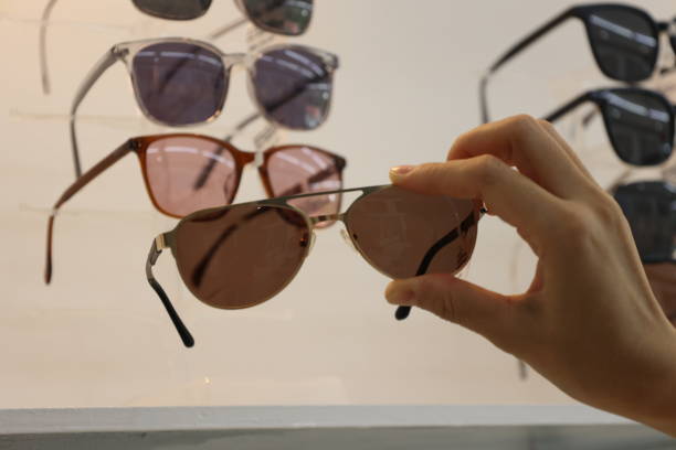 istock Hand holding sunglasses in optical shop 1488499397