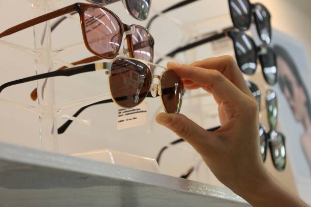 istock Hand holding sunglasses in eyeglasses shop 1488499407