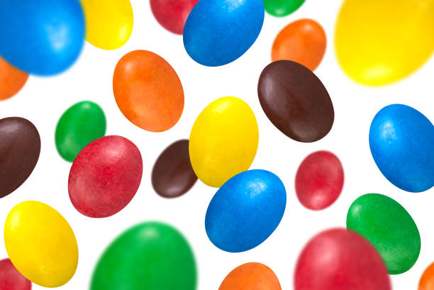 istock Levitation of multicolored glazed dragee isolated on white background. 1488504072
