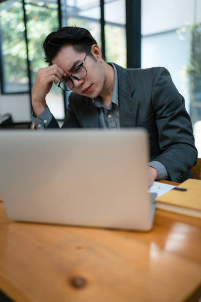 istock Portrait of business owner, man using computer and financial statements Anxious expression on expanding the market to increase the ability to invest in business. 1488504297