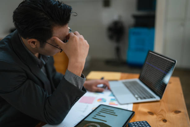 istock Portrait of business owner, man using computer and financial statements Anxious expression on expanding the market to increase the ability to invest in business. 1488504315