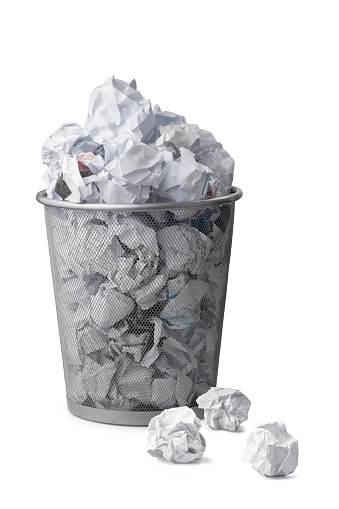 Trash bin with paper waste on white background