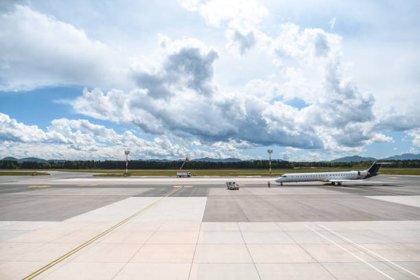 Airplane moving around at the airport. Dragged by pushback tug and set to a correct position.