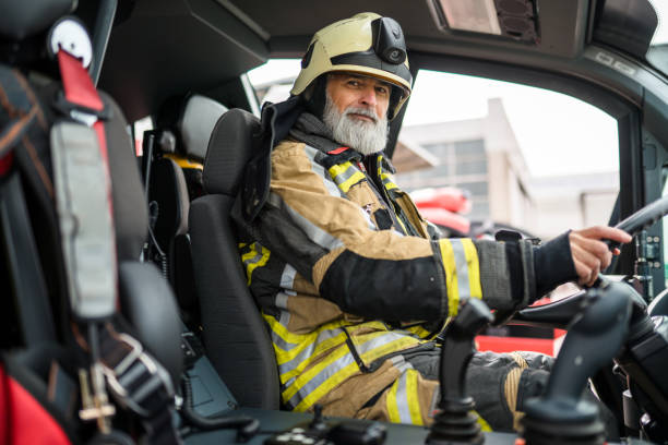 istock Senior Caucasian Firefighter Driving A Firetruck 1488506975