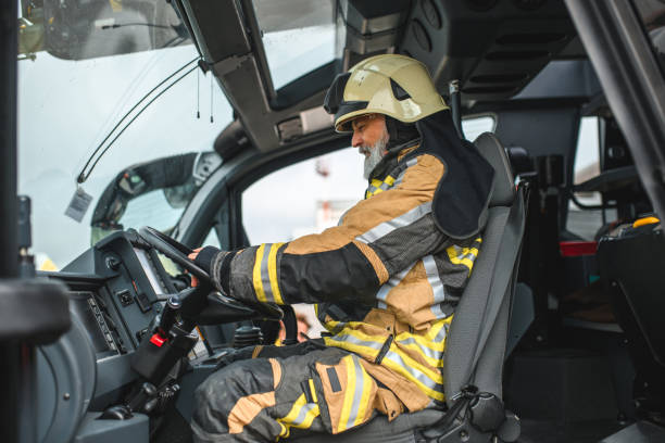 istock Senior Caucasian Firefighter Driving A Firetruck 1488506997