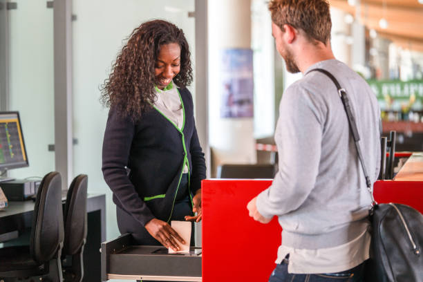 istock Female Afro-American Flight Attendant Scanning  Boarding Pass 1488507859