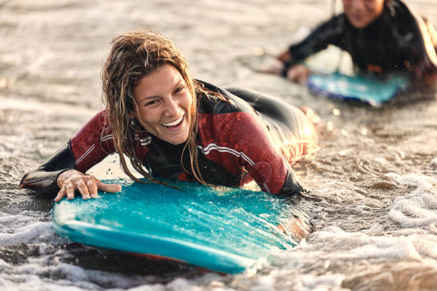 istock Carefree woman having fun while surfing in sea. 1488514027