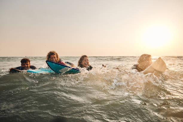 istock Cheerful surfers having fun in summer day at sea. 1488514220