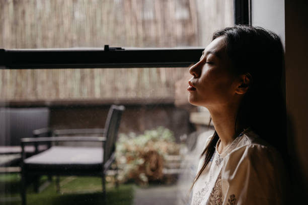 istock Despaired woman sitting by the window 1488514262