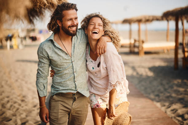 istock Happy couple walking in summer day on the beach. 1488514672