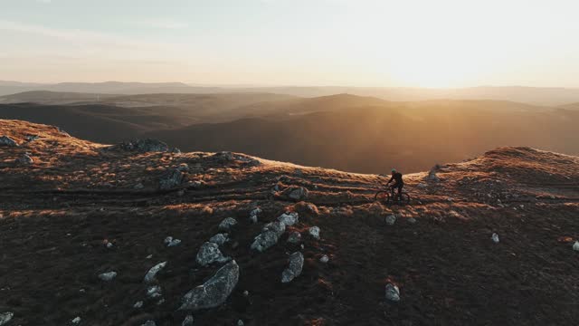 Drone Shot Of A Mountain Biker Going Down A Hill