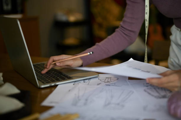 istock A tailor using laptop and working on her new costume collection design in a studio. 1488518283