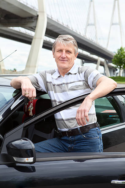 istock Happy mature driver with ignition key near the car 148851907