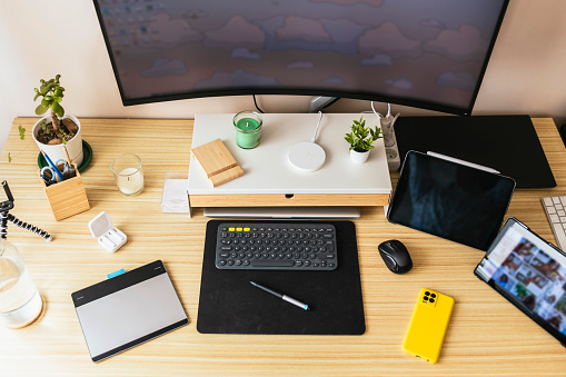Home work desk for teleworking. Phone, tablets, headphones, monitor...