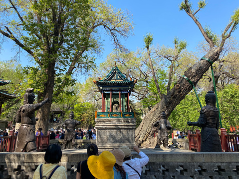 Taiyuan, Shanxi, China- April 30, 2023: Jinci Temple (Jin Ancestral Temple), built to commemorate Tang Shuyu, the founder of Jin State (1033 B.C. - 376 B.C.) and his mother, is a combination of ancestral temple sacrificial architecture and natural landscape. There are many valuable architectures, murals, sculptures that have been existing for hundreds of years. Here is the Iron Man Terrace.