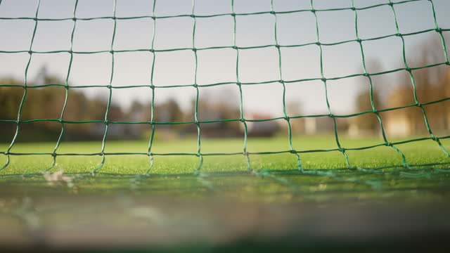Close-up of the net in a soccer goal, seen from behind the soccer goal