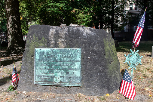 Boston, MA, USA-August 2022; Close up of the grave markers of Samuel Adams on the Granary Burying Ground on Tremont Street where also Paul Revere and John Hancock are buried