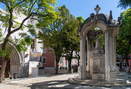 Lisbon, Portugal-October 2022: Close up of the Chafariz do Carmo fountain on Largo de Carmo square surrounded by jacaranda trees, entrance of the former Carmo Convent and other historic buildings