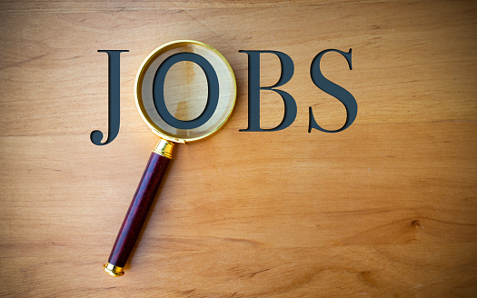 The word Jobs and a magnifying glass on a desk