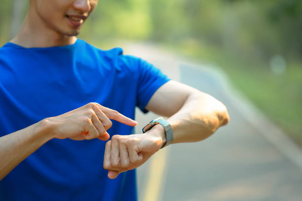 istock Young athletic man in sportswear checking workout results or progress update on smartwatch. Technology health, wellness. 1488525560