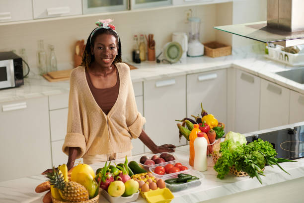 istock Woman Standing at Kitchen Counter 1488526303