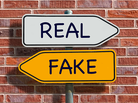 Real or fake concept represented on two opposite direction signs