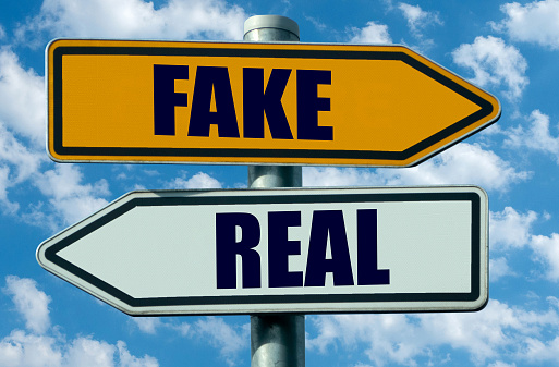 Real or fake concept represented on two opposite direction signs