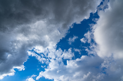 clouds and storm clouds are closing in blue sky