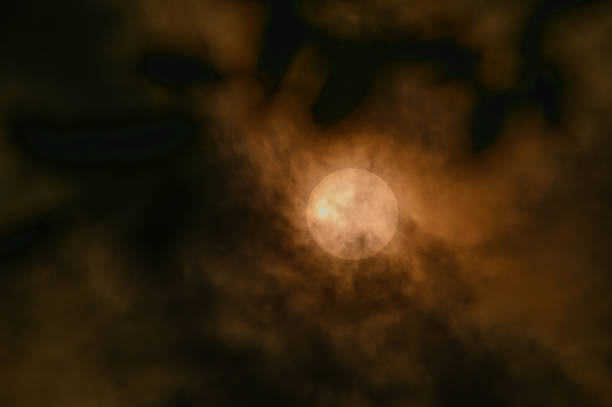 Sun Disappears and Reappears Behind Clouds. A fleeting moment of darkness.