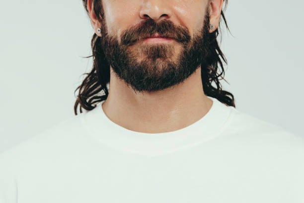 istock Man with a beard and perfect skin standing in a studio 1488528414