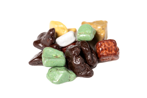 Glazed chocolates. Pebble chocolate isolated on white background. Sweet dragee stones. Desserts for Candybar. Small multi-colored candies