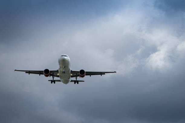 istock Low Angle View Of Landing Airplane Against Sky 1488529443