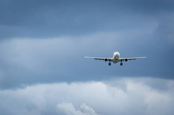 istock Low Angle View Of Landing Airplane Against Sky 1488529480