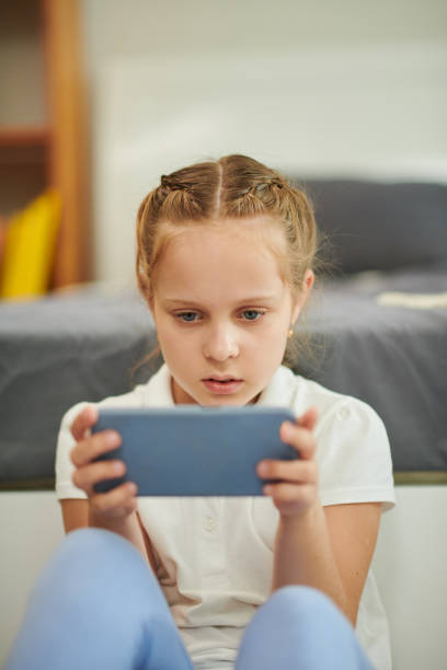 istock Girl Playing Game on Smartphone 1488529699