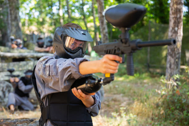 istock Woman targeting and shooting with paintball gun 1488532672