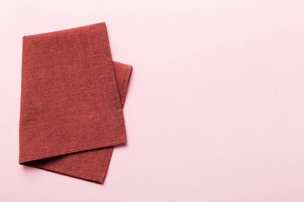 istock top view with red empty kitchen napkin isolated on table background. Folded cloth for mockup with copy space, Flat lay. Minimal style 1488532837